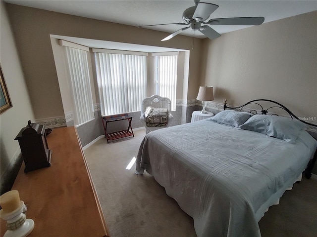 bedroom featuring ceiling fan and carpet