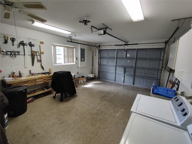 garage featuring a garage door opener, a workshop area, ceiling fan, and washer / dryer