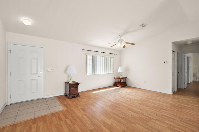 foyer entrance with ceiling fan and light hardwood / wood-style flooring