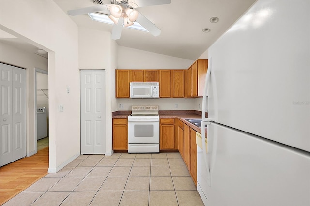 kitchen featuring white appliances, lofted ceiling, ceiling fan, light tile patterned flooring, and washer / clothes dryer