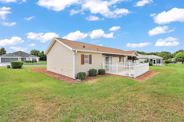 rear view of property with a lawn