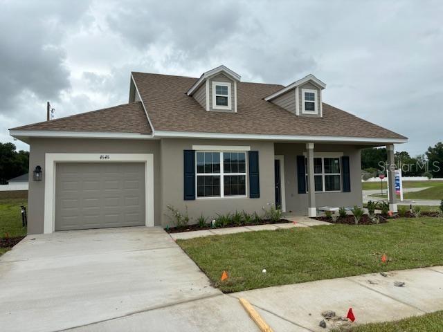 view of front of house with a garage and a front yard