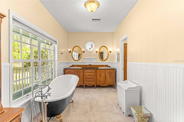 bathroom with vanity and a tub