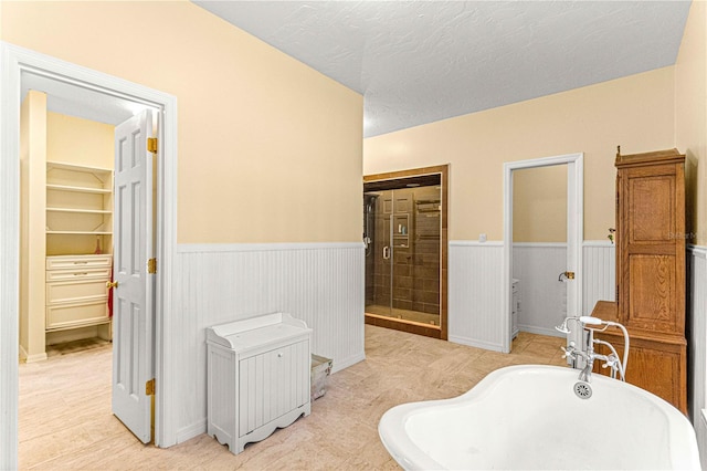 bathroom with a textured ceiling and plus walk in shower