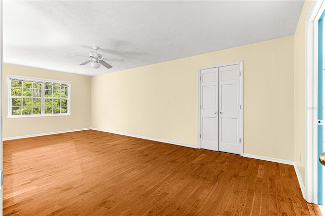 spare room featuring ceiling fan and hardwood / wood-style floors