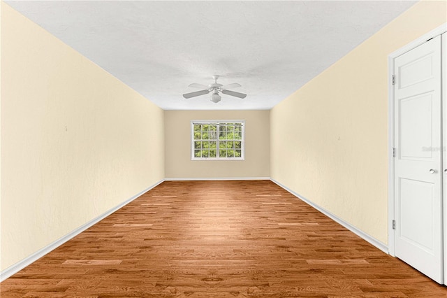 spare room with ceiling fan and hardwood / wood-style floors