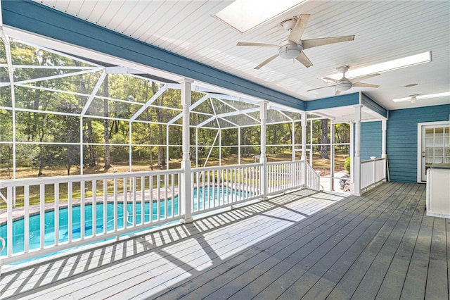 view of pool with glass enclosure and a patio area