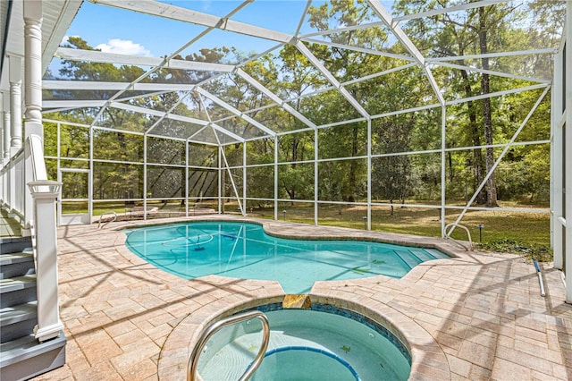 view of swimming pool with glass enclosure, an in ground hot tub, and a patio