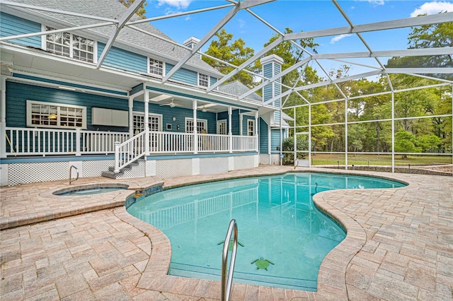 view of swimming pool with an in ground hot tub, a patio, and a lanai