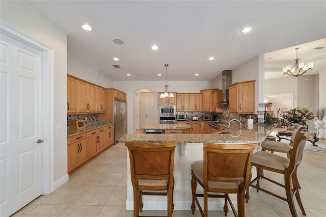 kitchen with backsplash, decorative light fixtures, appliances with stainless steel finishes, and a chandelier