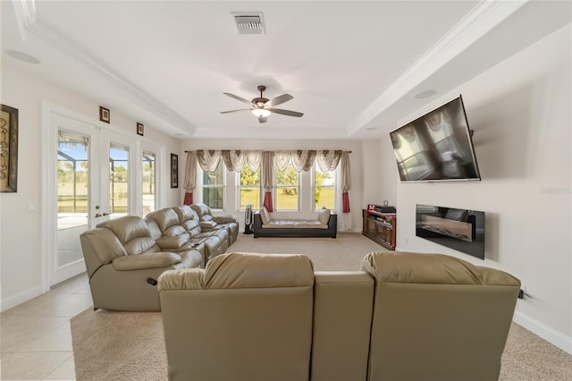 living room featuring french doors, a tray ceiling, ceiling fan, and light tile floors