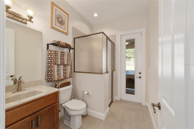 bathroom with toilet, a shower with door, tile floors, and large vanity