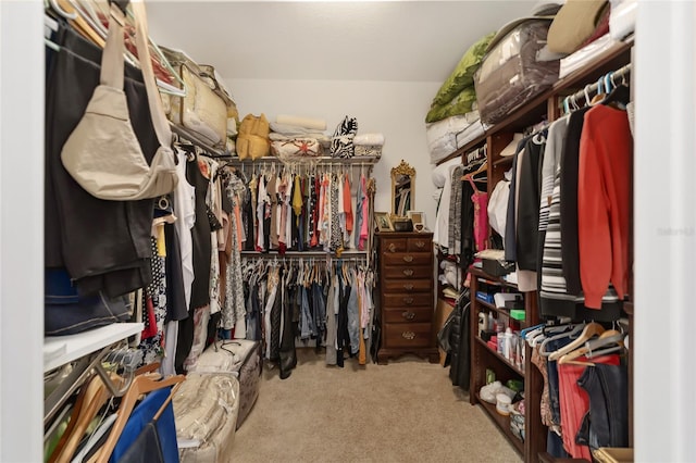 walk in closet featuring light carpet