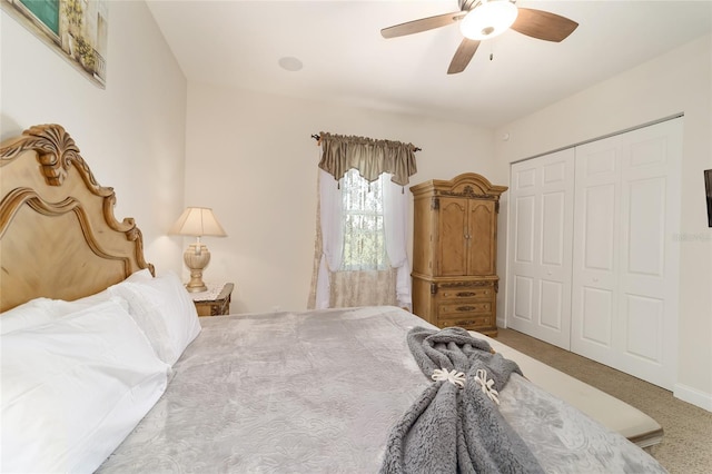 bedroom featuring light colored carpet, a closet, and ceiling fan