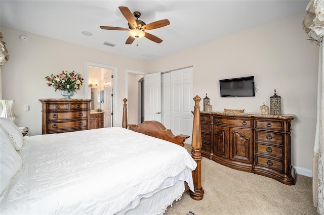 carpeted bedroom featuring connected bathroom, a closet, and ceiling fan