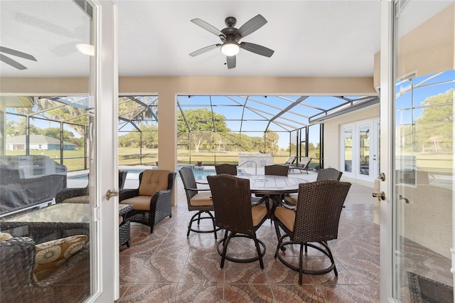 sunroom featuring french doors, ceiling fan, and a wealth of natural light