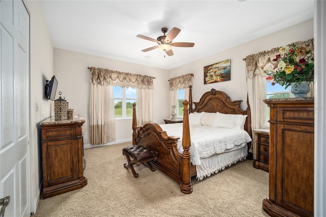 bedroom featuring light carpet, a closet, and ceiling fan