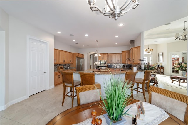 interior space featuring light tile floors and a chandelier