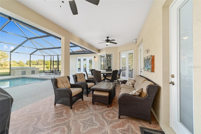 sunroom / solarium with plenty of natural light, ceiling fan, french doors, and a pool