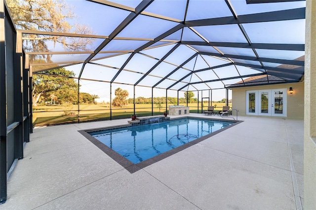 view of pool with a patio, french doors, and glass enclosure