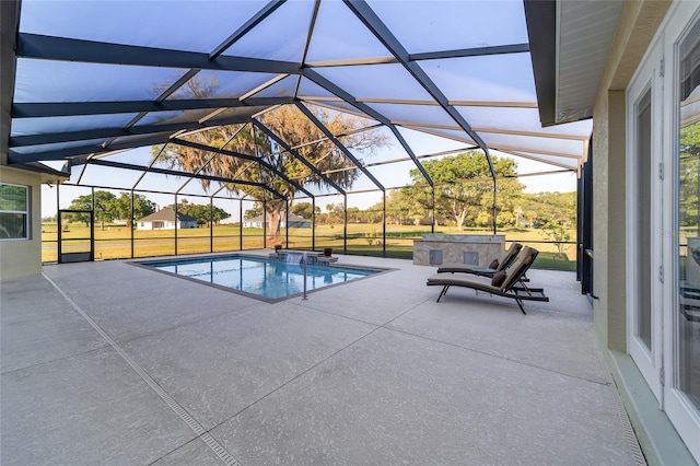 view of swimming pool featuring a patio area and a lanai