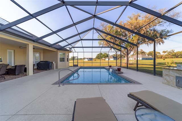 view of pool featuring area for grilling, a patio area, a lanai, and a lawn