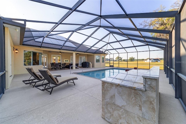 view of swimming pool with a patio area and a lanai