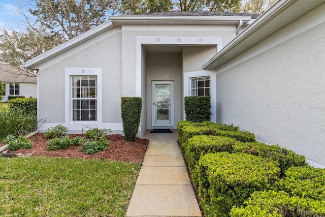 entrance to property with stucco siding