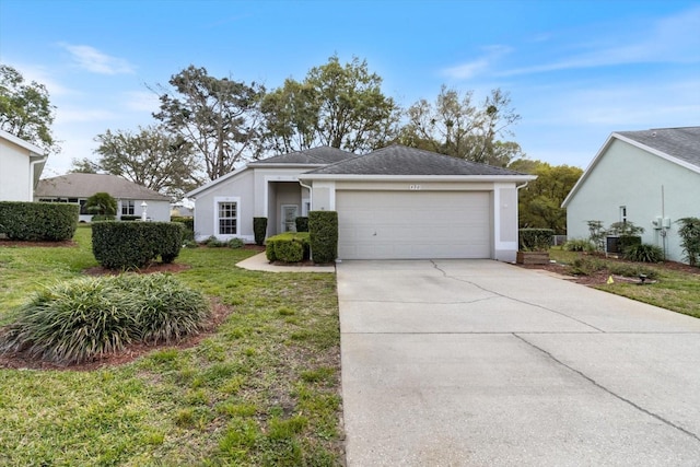 view of front facade with concrete driveway, a front lawn, an attached garage, and stucco siding