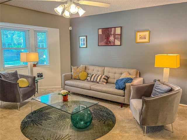 living room with light carpet, ceiling fan, and a textured ceiling