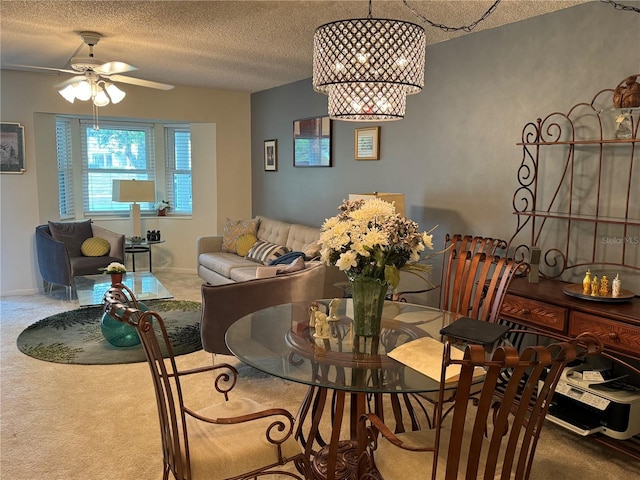 carpeted dining area featuring ceiling fan and a textured ceiling