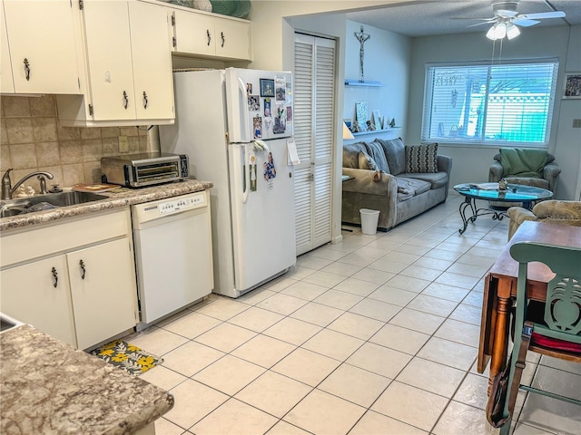 kitchen featuring backsplash, ceiling fan, sink, white cabinets, and white dishwasher