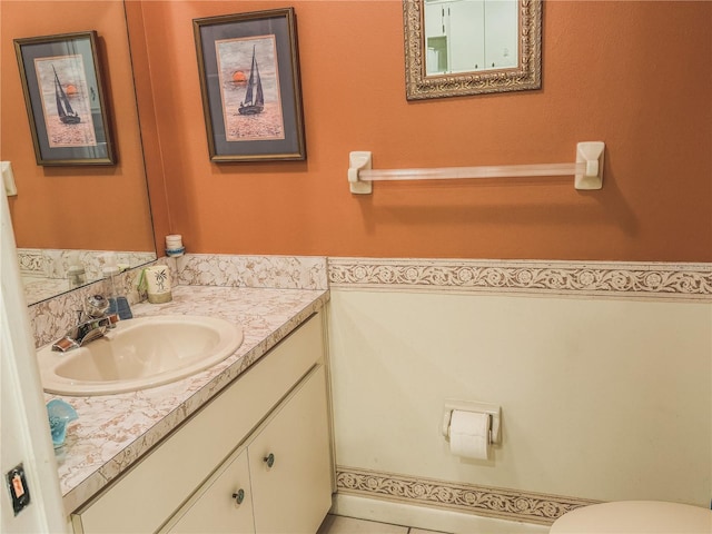 bathroom featuring oversized vanity and toilet