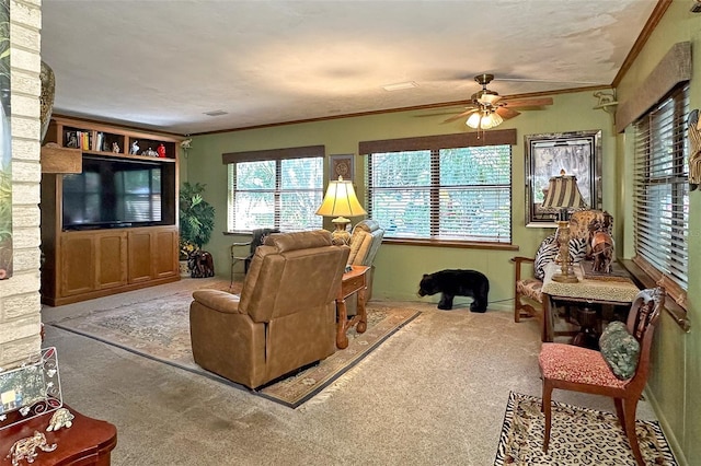 living room with crown molding, ceiling fan, and light colored carpet