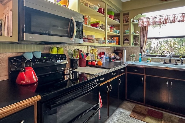 kitchen with light tile floors, sink, and black range with electric cooktop