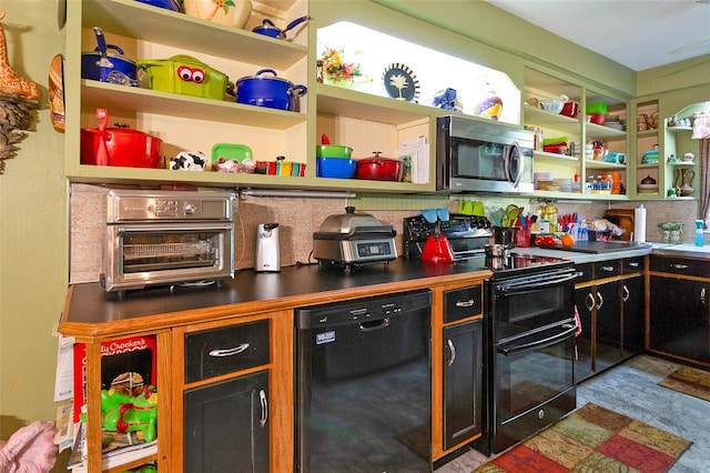 kitchen featuring dark tile flooring and black appliances