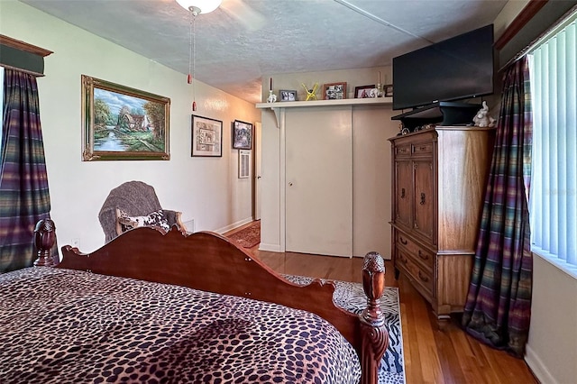 bedroom featuring hardwood / wood-style floors and ceiling fan