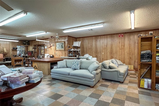 interior space featuring wooden walls, ceiling fan, and a textured ceiling