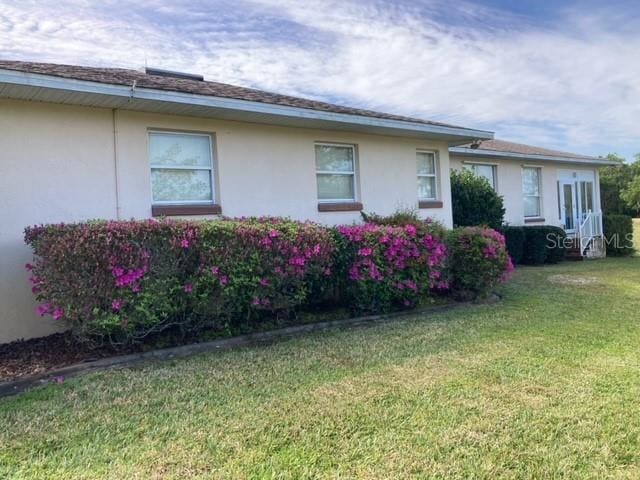 view of property exterior featuring a yard