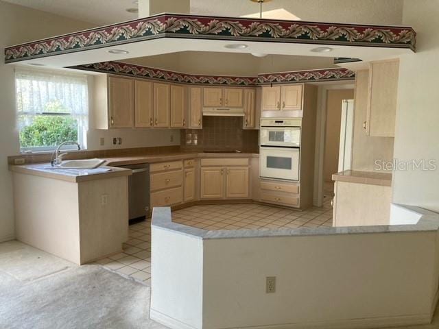 kitchen featuring stainless steel dishwasher, light tile flooring, white double oven, tasteful backsplash, and sink