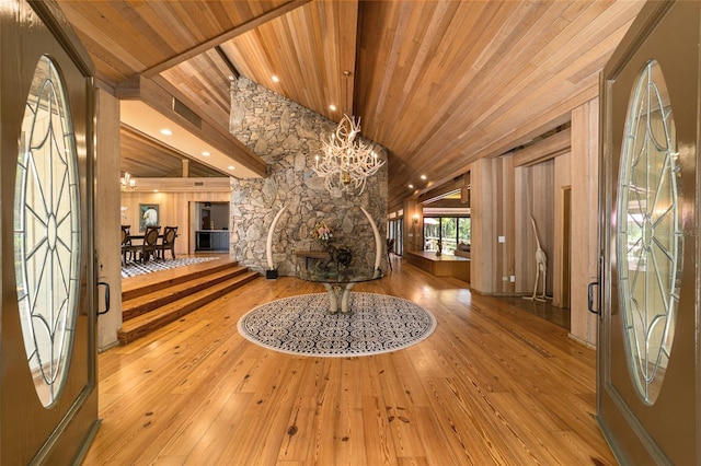 foyer featuring a notable chandelier, wooden ceiling, and light hardwood / wood-style flooring