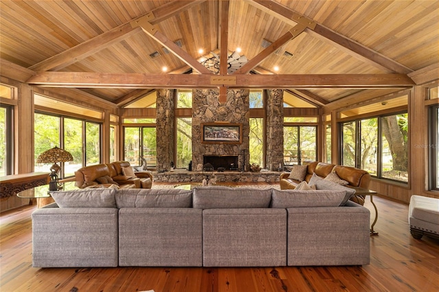 living room with light hardwood / wood-style flooring, wood ceiling, and a fireplace