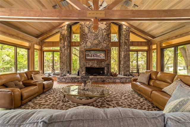 living room featuring hardwood / wood-style floors, wooden ceiling, a stone fireplace, and beamed ceiling