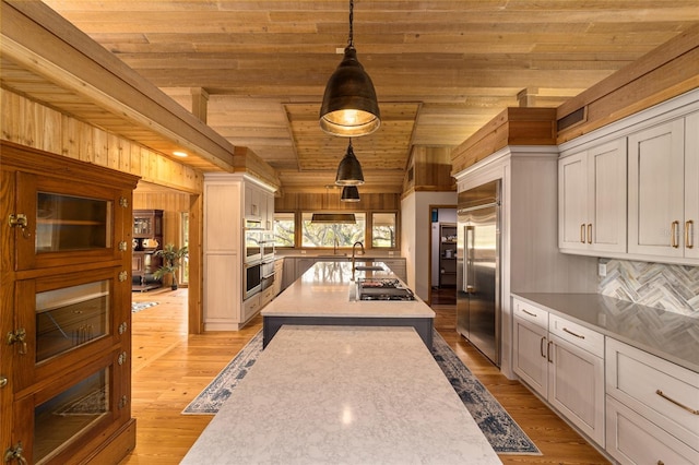 kitchen with pendant lighting, wooden ceiling, light wood-type flooring, and white cabinetry