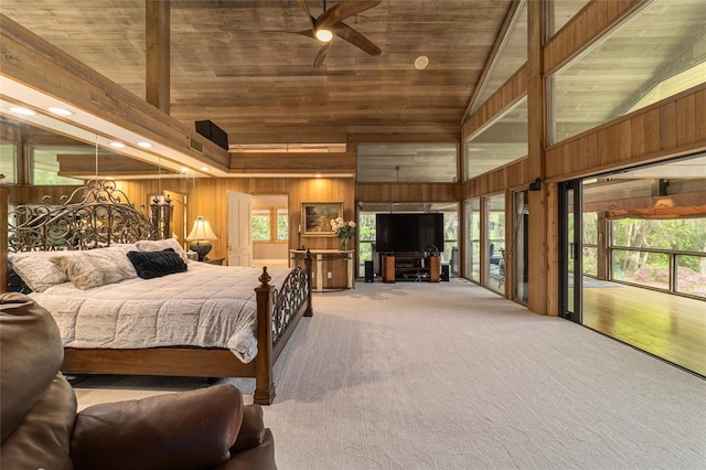 bedroom with wooden walls, wooden ceiling, light colored carpet, and multiple windows