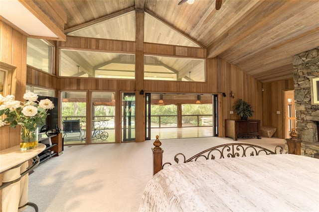 carpeted bedroom featuring high vaulted ceiling, access to exterior, wooden ceiling, and a stone fireplace