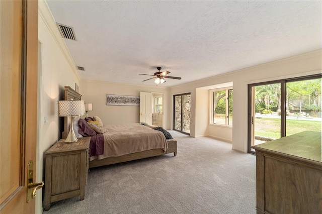 carpeted bedroom with a textured ceiling, ornamental molding, access to exterior, and ceiling fan