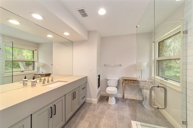 bathroom with toilet, large vanity, and tile flooring