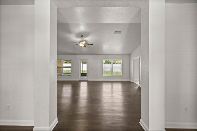 interior space featuring dark hardwood / wood-style floors, a textured ceiling, ceiling fan, and vaulted ceiling