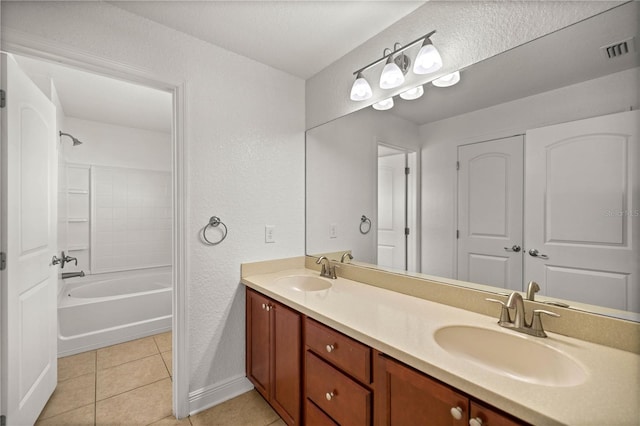 bathroom with shower / washtub combination, vanity with extensive cabinet space, dual sinks, and tile floors